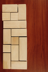 Wooden toy blocks on wooden background