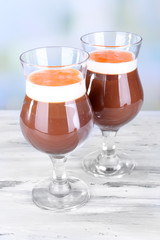 Dessert of chocolate and persimmon on table on light background