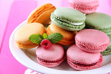 Gentle macaroons in vase on table close-up