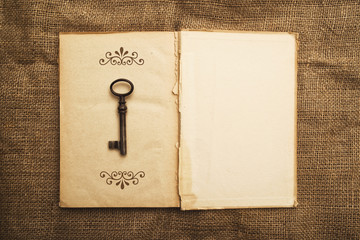 Old open book and rusty key