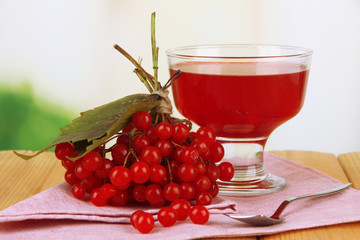 Red berries of viburnum and bowl with jam