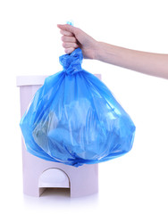 Hand holding trash bag, isolated on white