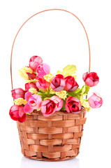 Bouquet of beautiful artificial flowers in wicker basket,