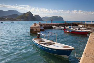 Fototapeta na wymiar Fishing boats float moored in Petrovac, Montenegro