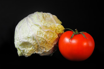 tomato and cabbage on a black background