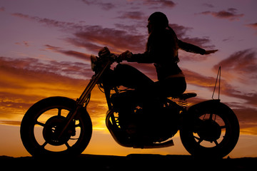 Fototapeta na wymiar Silhouette woman motorcycle ride hand back