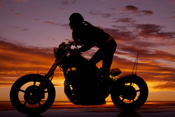 Fototapeta na wymiar Silhouette woman motorcycle stand lean forward