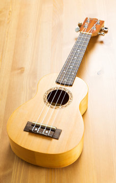 Ukulele on wood background