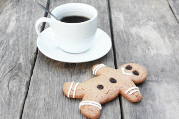 Gingerbread man with coffee on wood