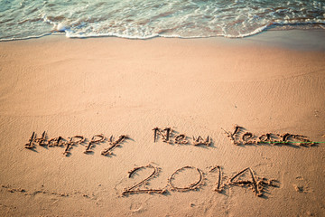 Writing Happy New Year's 2014 on the Beach in Thailand