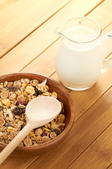 Plate with raw oatmeal on wooden table.