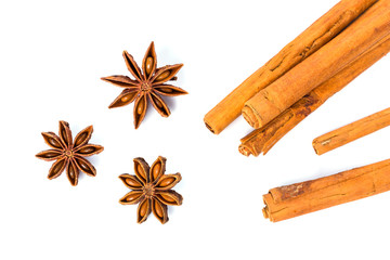 Anise stars and cinnamon sticks over white background