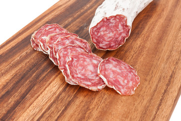 sliced salami on wooden board