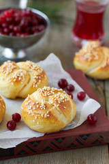 Obraz na płótnie Canvas Homemade bread rolls with sesame seeds and cranberry