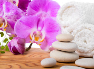 Fototapeta na wymiar Spa still life with stone, lilac orchid and towel