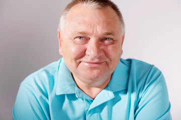 Smiling senior man closeup over white