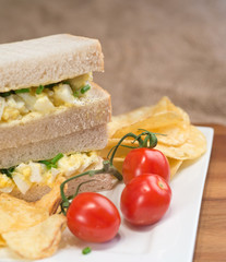 Fresh egg on white sandwich in rustic kitchen setting