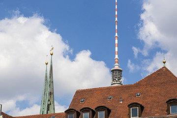 steeple and top of the berlin tv tower behind a red roof © Armin Staudt