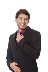 Man correcting a tie