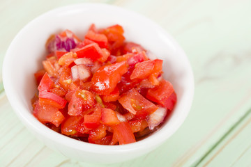 Tomato Salsa - Mexican tomato dip in a white bowl.