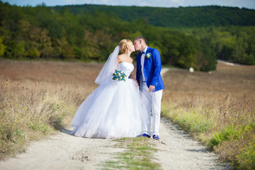 Fototapeta premium happy bride and groom at a park on their wedding day