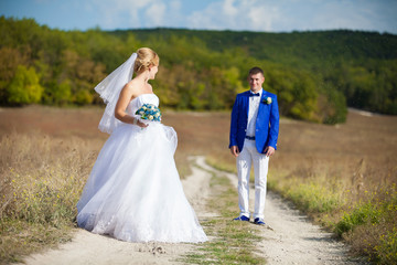 Fototapeta na wymiar happy bride and groom at a park on their wedding day