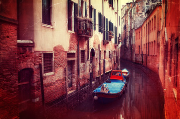 Retro style image of small canal in Venice