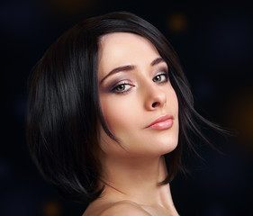 Beautiful woman with short black hair looking sexy. Closeup