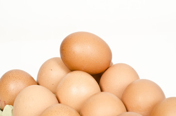 Brown eggs in the basket on a white