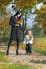 Fototapeta premium little boy with his mother in autumn park