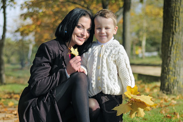 little boy with his mother in autumn park