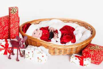 little santa baby with christmas hat lying in basket