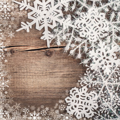 Christmas snowflakes on wooden background