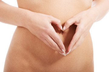 Feamle's flat belly with heart hand shape.
