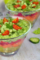Tasty salad with fresh vegetables on wooden table