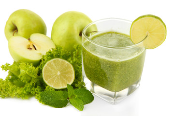 Glass of green vegetable juice apple and lime close up
