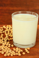 Soy beans with glass of milk on wooden background