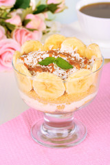 Delicious dessert with banana and caramel on table close-up