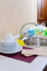 Dishes drying near  metal sink