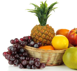 Ripe fruits in basket isolated on white