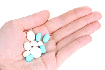 Pills in hand isolated on white