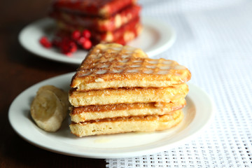Sweet waffles on  plates. on wooden background
