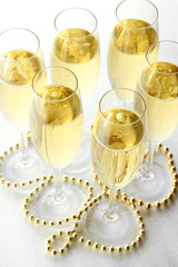 Glasses with champagne on shiny background