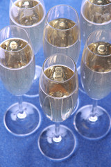 Glasses with champagne on shiny background