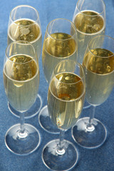Glasses with champagne on shiny background