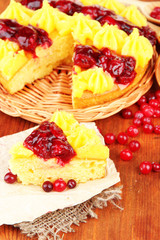 Tasty fruity homemade pie with berries, on brown wooden table