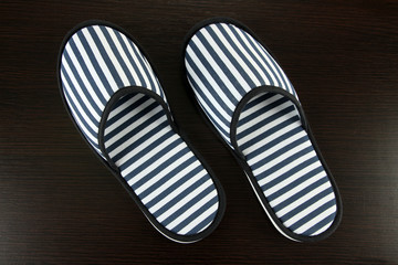 Striped slippers on wooden background
