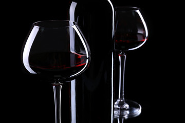 Wineglasses with red wine, isolated on black