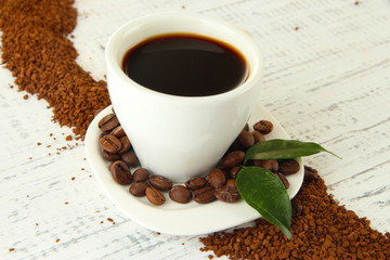 Cup of coffee with instant coffee on wooden background