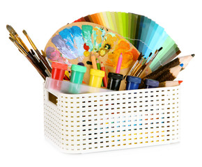 Plastic basket with art supplies isolated on white